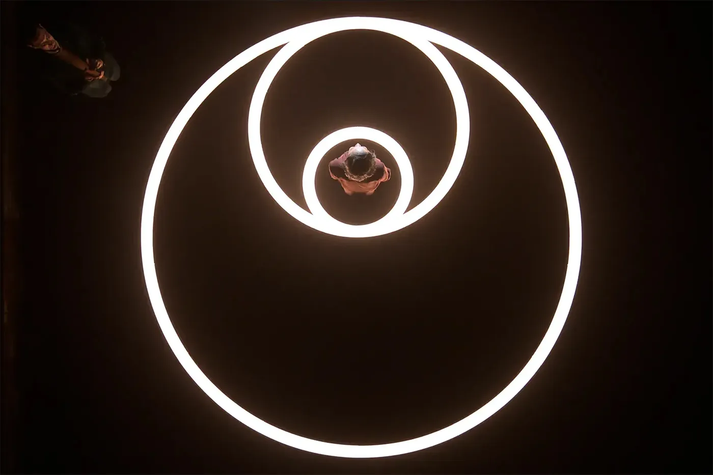Three overlapping circular trails of light, used as a visual metaphor for interconnected systems.